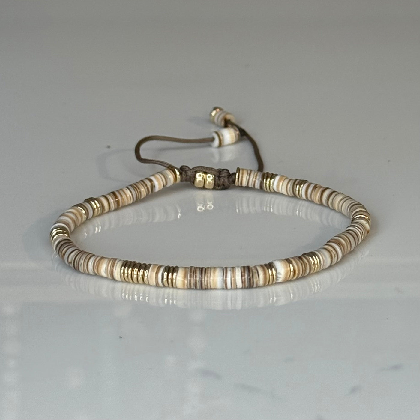 Silver Lining Bracelet in Natural Puka Shell with gold filled Beads on brown Cord